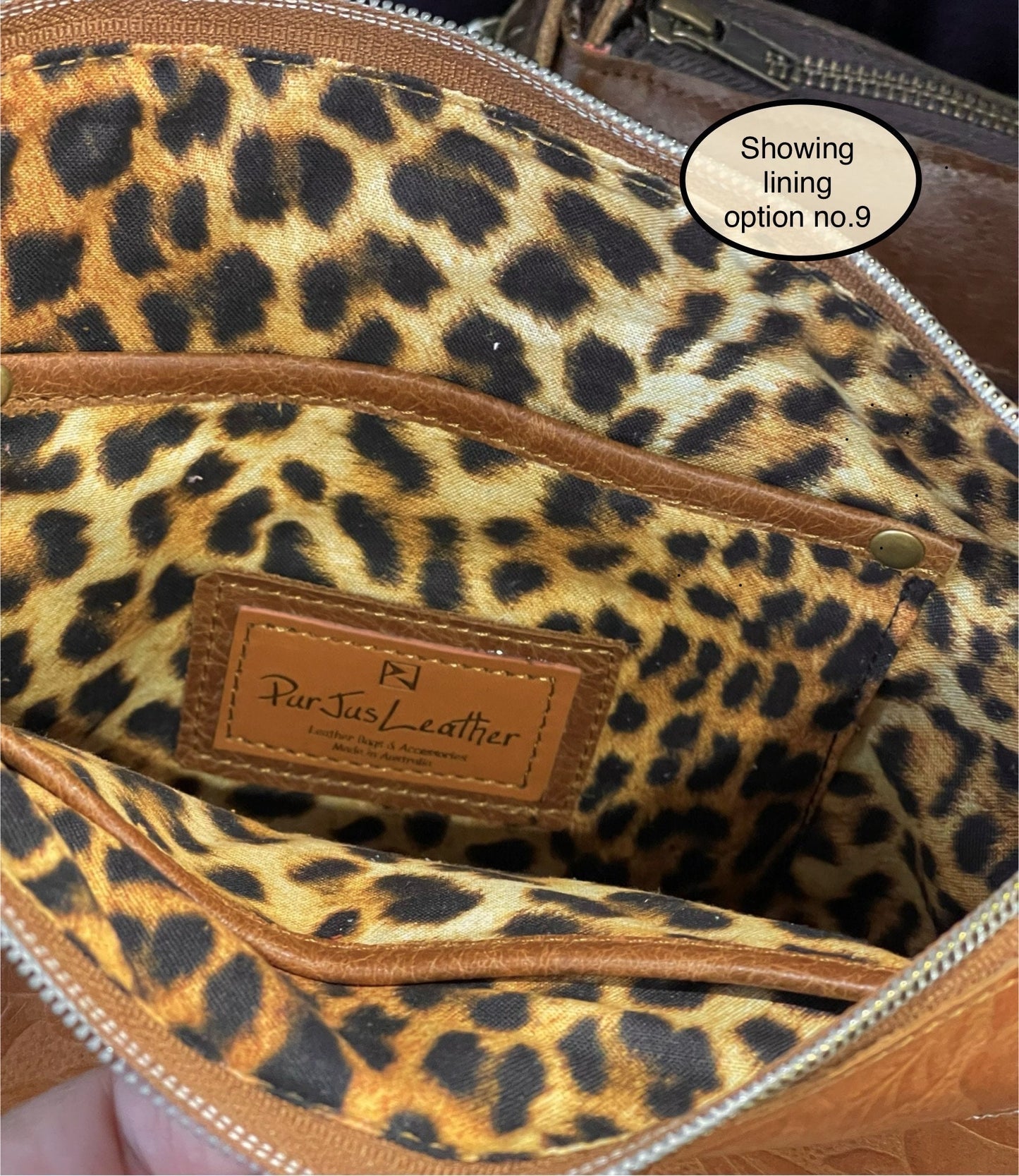 Leopard print lining inside tan leather bag with zipper closure