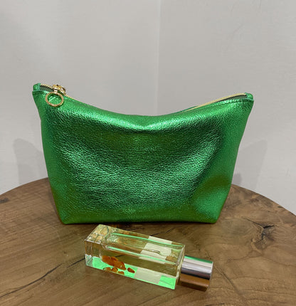 Medium size Green metallic makeup purse shown with a perfume bottle.