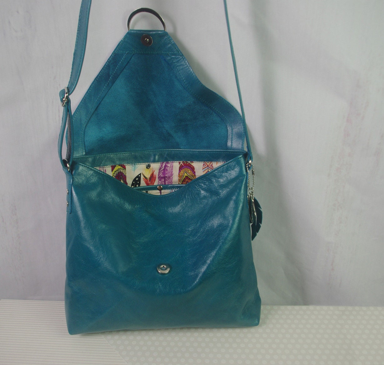 teal leather bag with inside lining showing