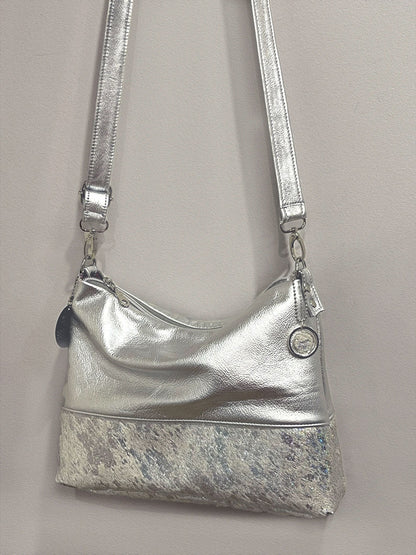 Silver handbag with a short hair iridescent base.  bag charm and removeable leather strap