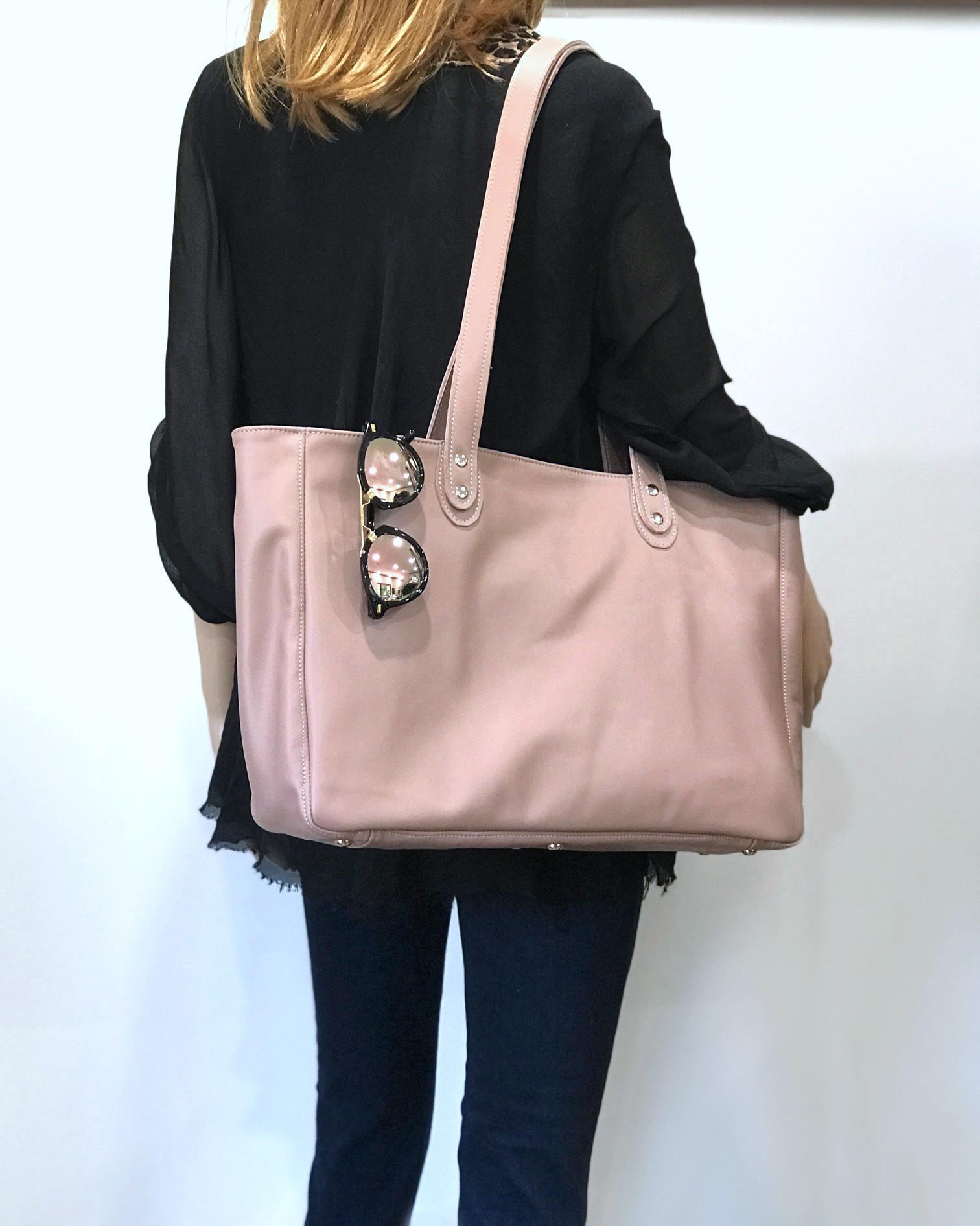 Person holding a blush pink tote bag with sunglasses and protective feet on bag and strong double handles double rivets