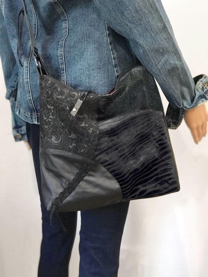 Person wearing a black textured bag over one shoulder 