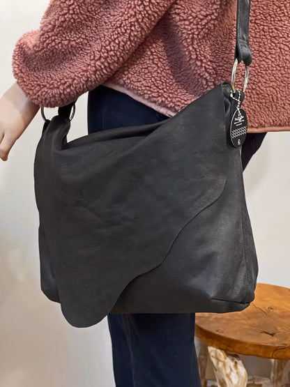 Distressed Black Leather Crossbody Bag with asymmetrical flap