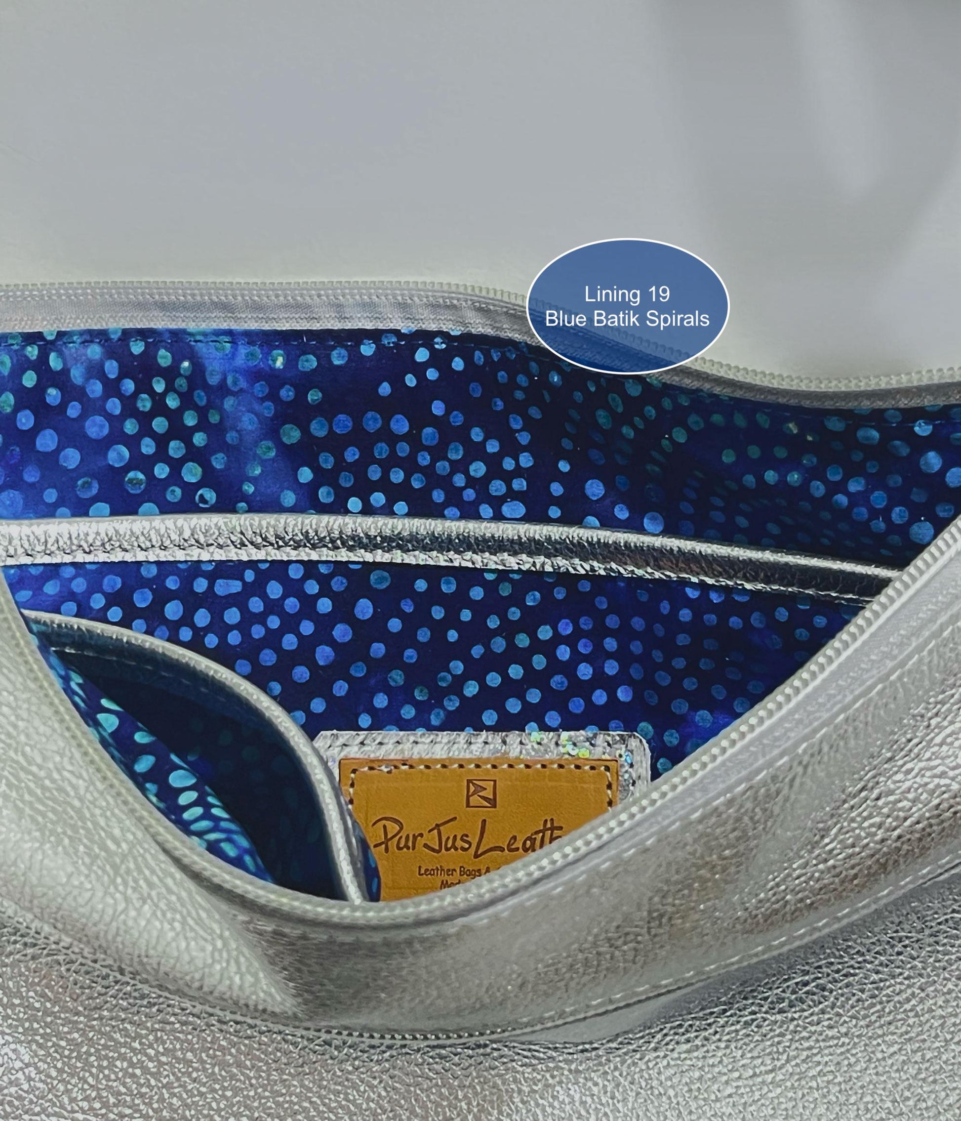 Close-up of a handbag interior with blue batik spirals lining and ParJus Craft logo.