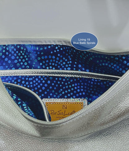 Close-up of a handbag interior with blue batik spirals lining and ParJus Craft logo.