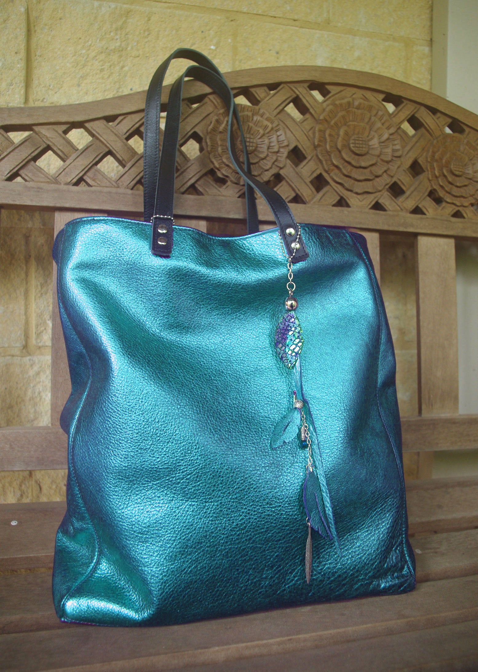 Turquoise handbag with decorative charm made from leather and beads