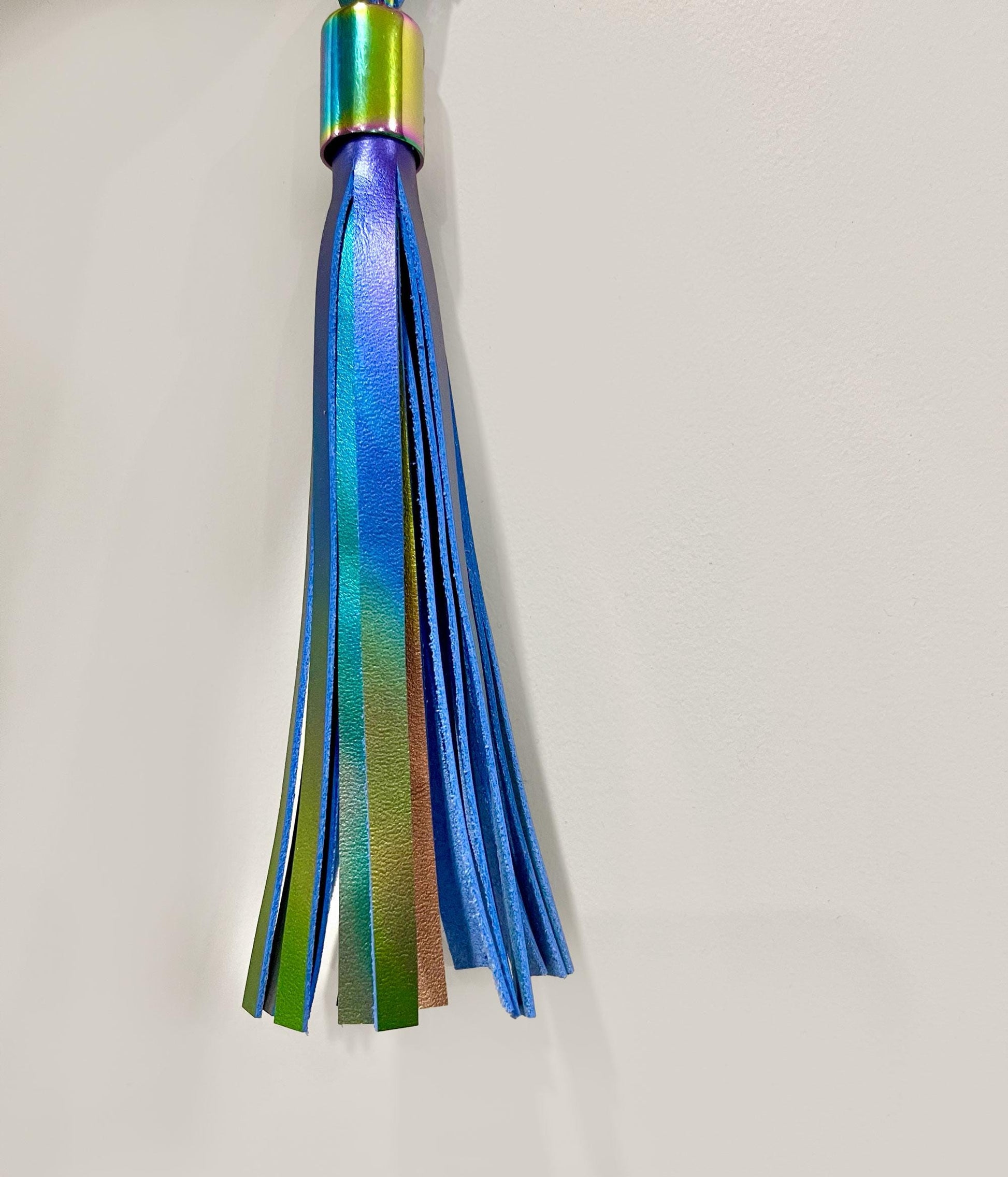 Multicolored tassel on a light gray background