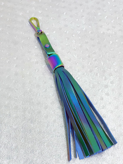 Multicolored tassel keychain on a textured white background