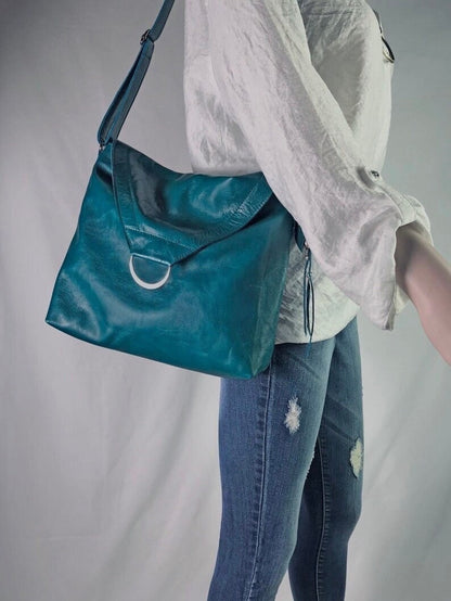 Teal leather bag with front flap and magnet closure