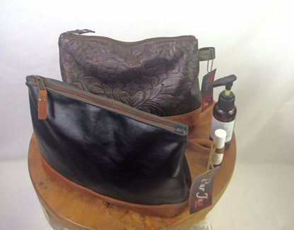 Two leather bags on a wooden stand with a white background