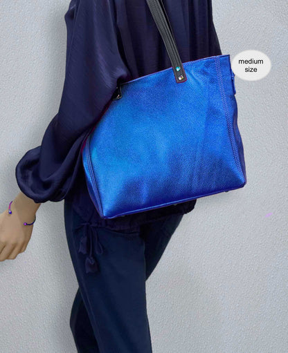 Person wearing a blue bag with a plain background