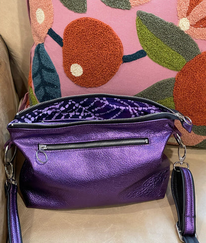 Purple handbag with purple lining  and open zipper