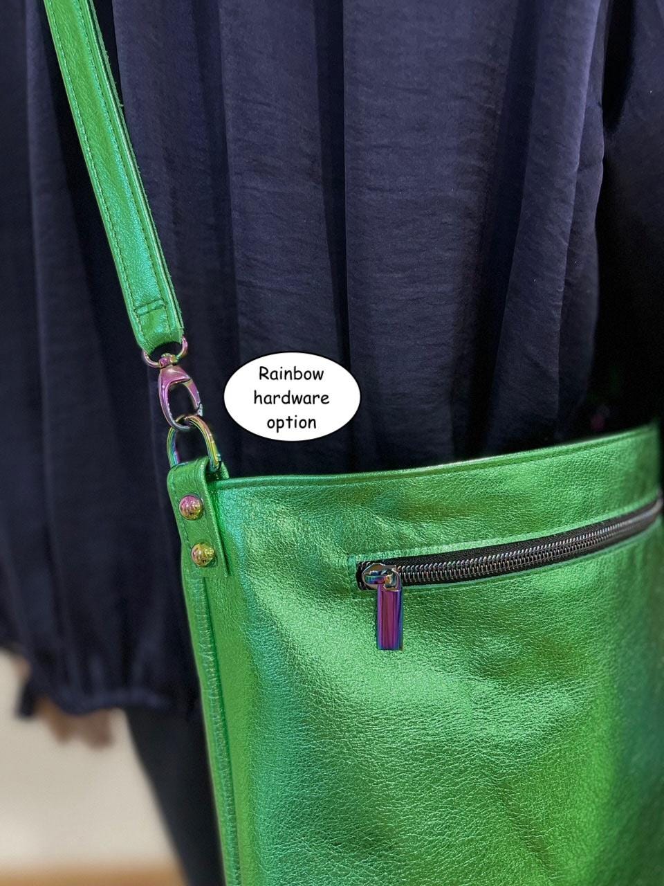 Green bag with rainbow hardware option on a dark blue background