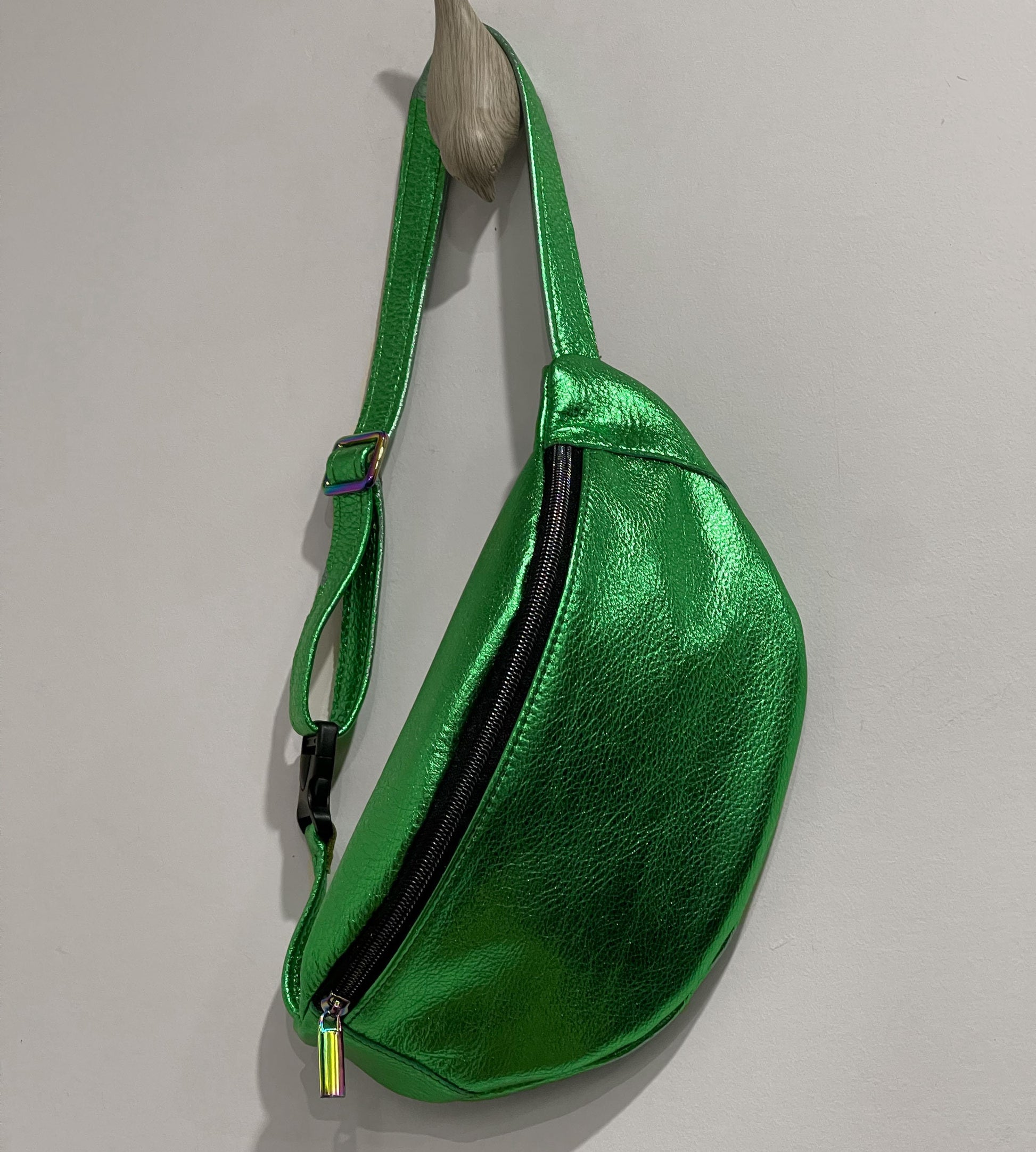 Green metallic fanny pack on a gray background