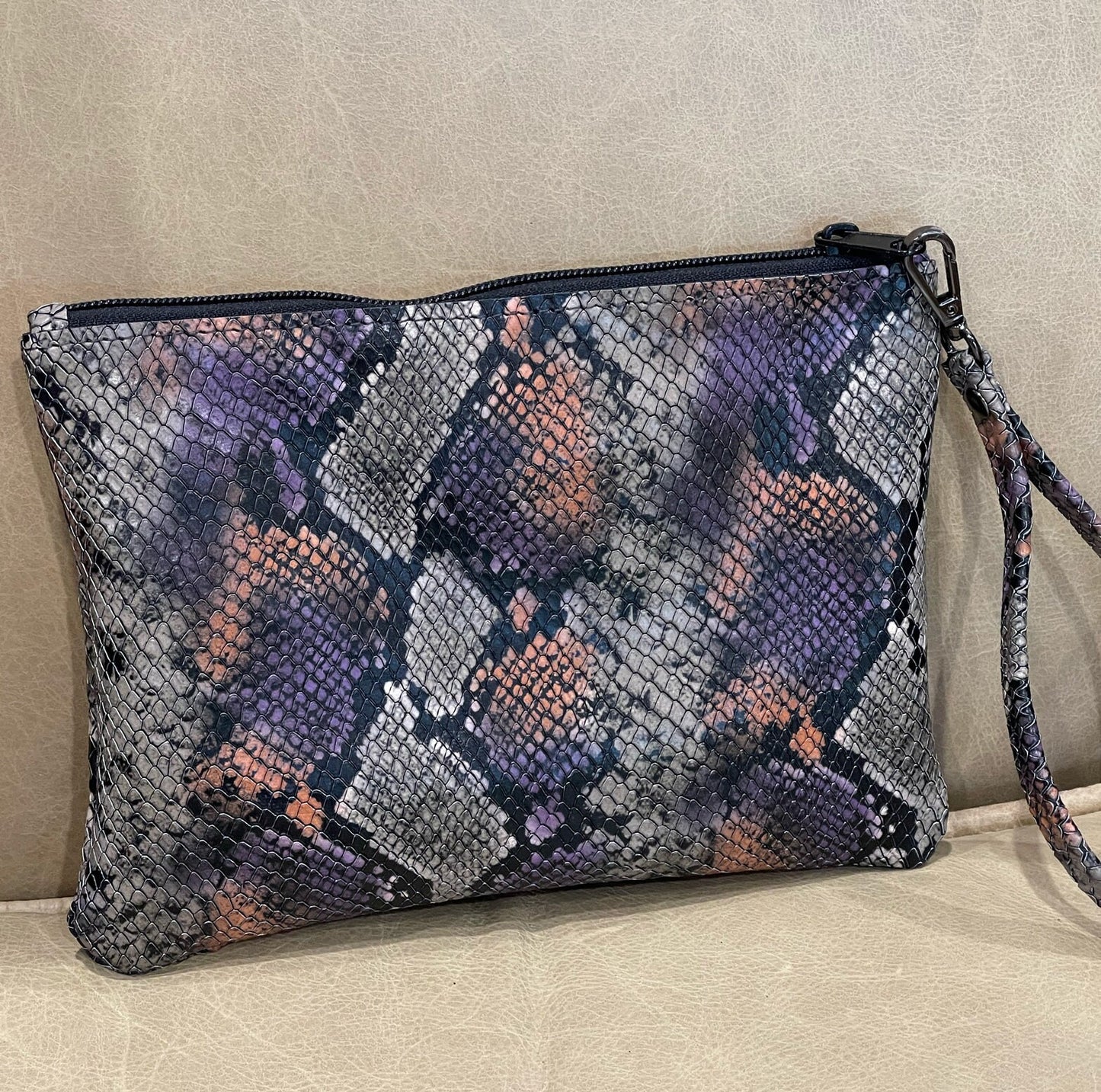 colourful snakeskin patterned zipper wristlet with a strap handle