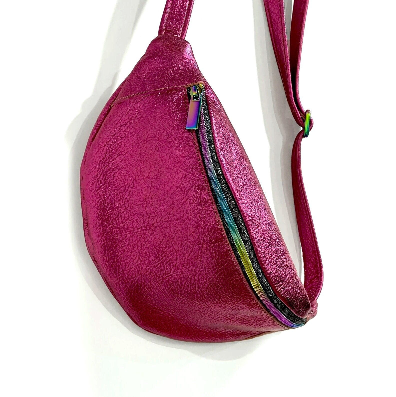 Pink leather bag with a rainbow zipper on a white background