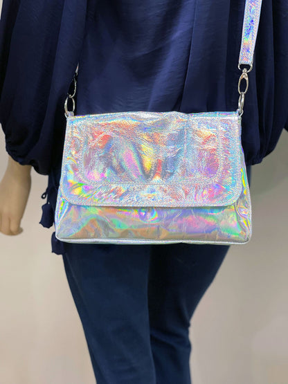 Holographic handbag worn by a person with a neutral background