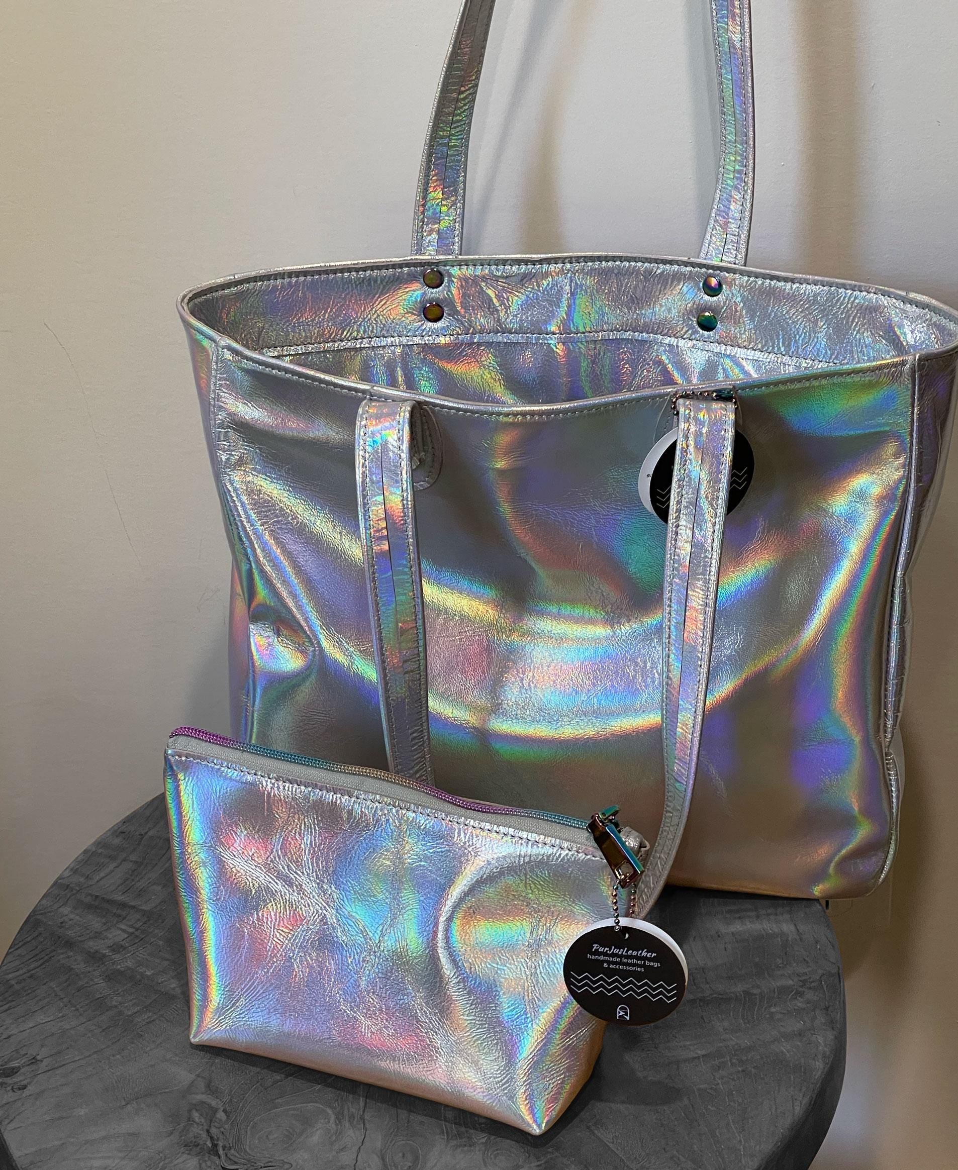 Holographic silver tote with matching pouch on a gray surface
