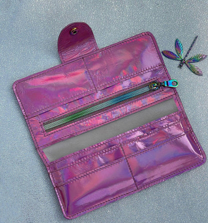 Holographic pink wallet with a dragonfly on a light gray background