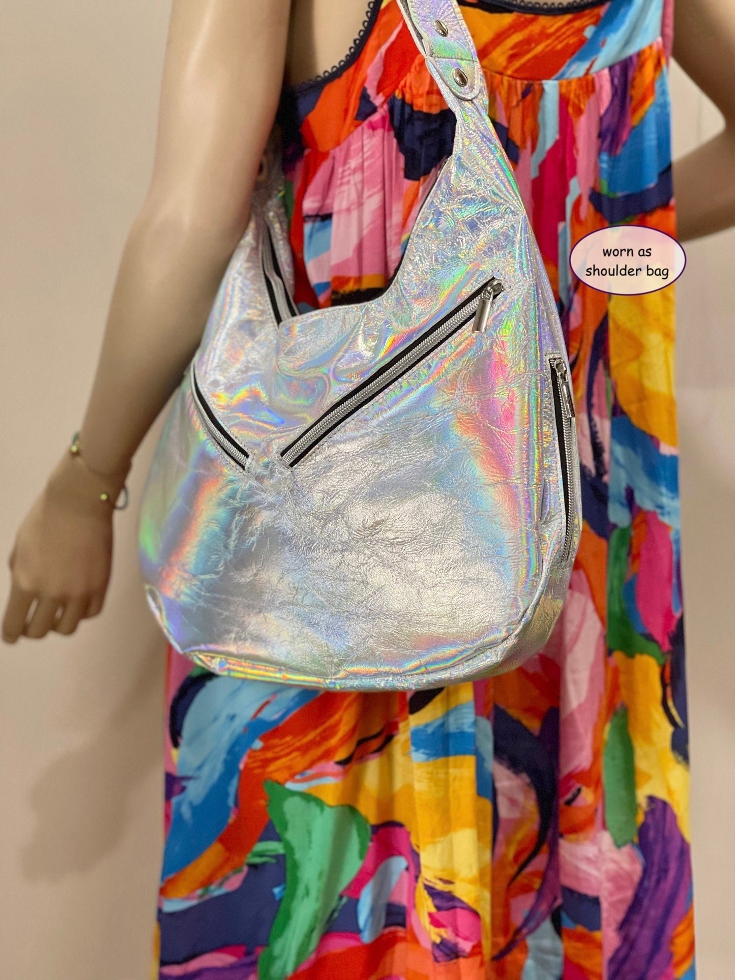 Holographic shoulder bag worn by a person in a colorful outfit