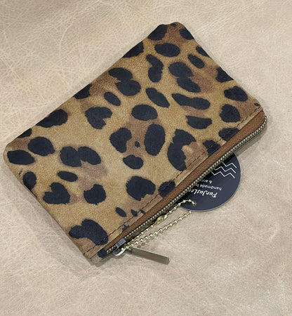 Leopard print wallet on a beige surface