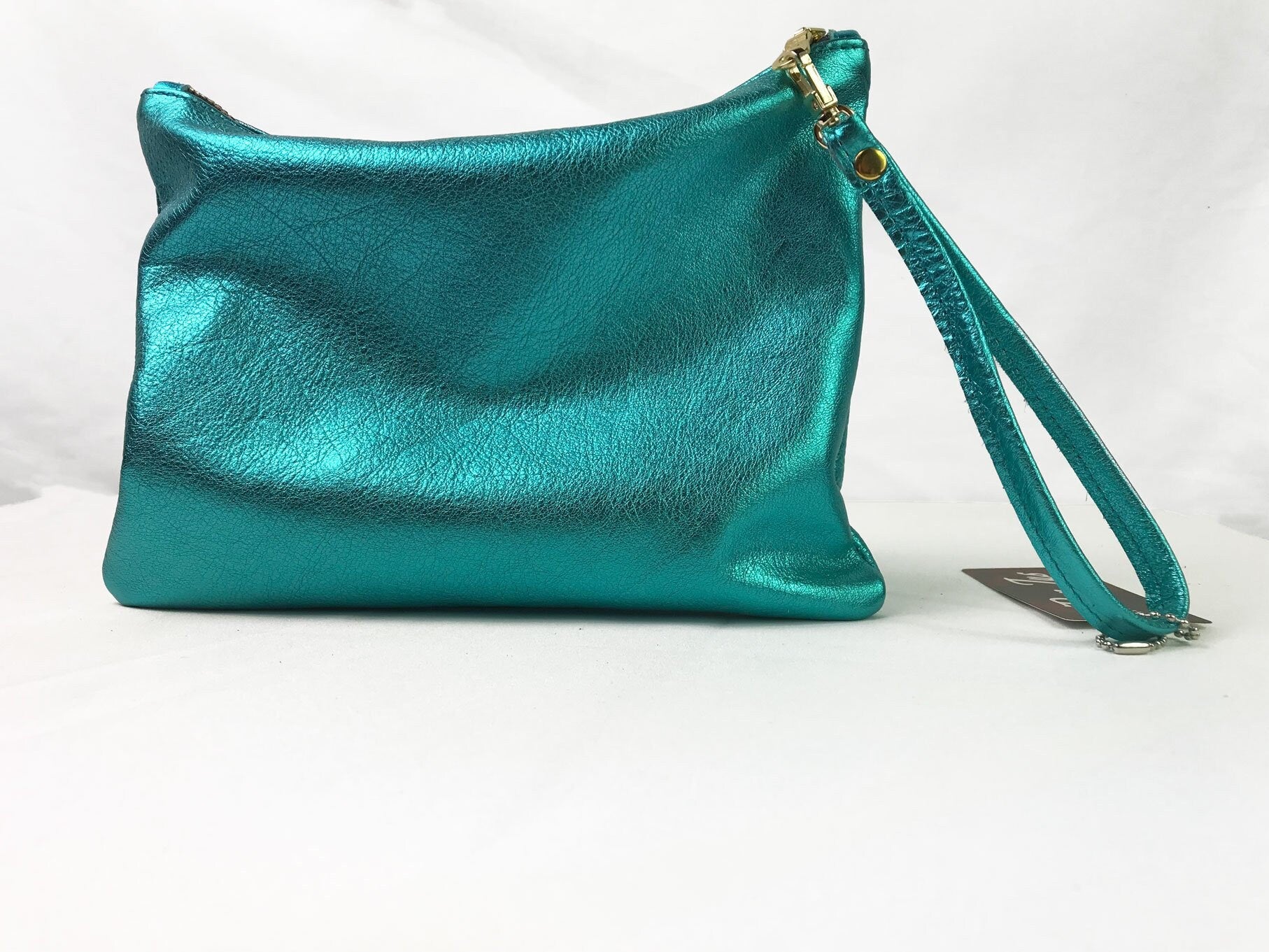 aqua turquoise clutch bag with a wrist strap for carrying essentials