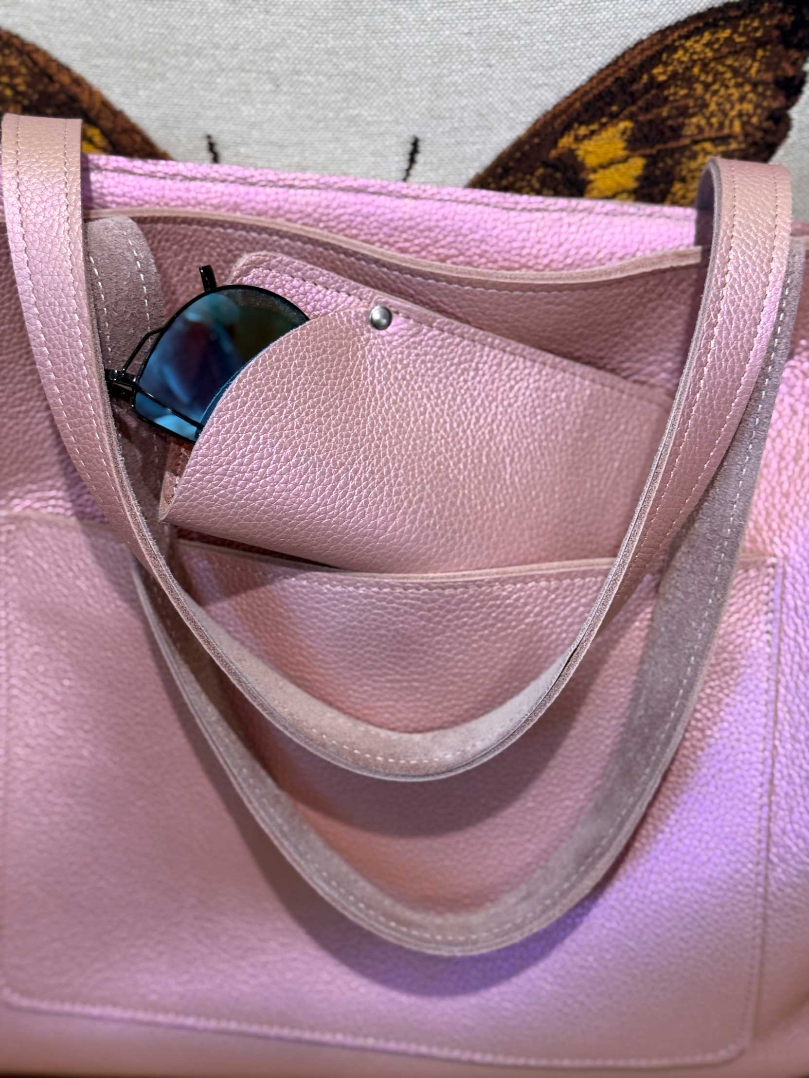 Pink handbag with sunglasses inside