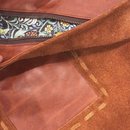 video of brown suede bag inside zip closure with close up image