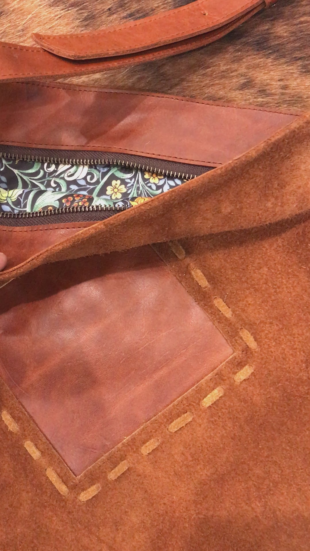 video of brown suede bag inside zip closure with close up image