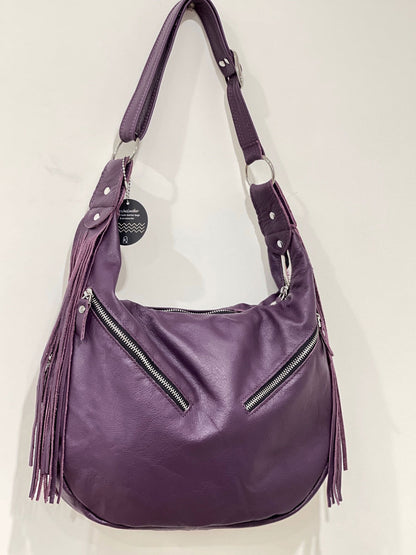 Purple handbag with fringe details on a white background