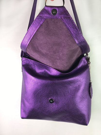 Purple leather bag showing open flap with magnet closure