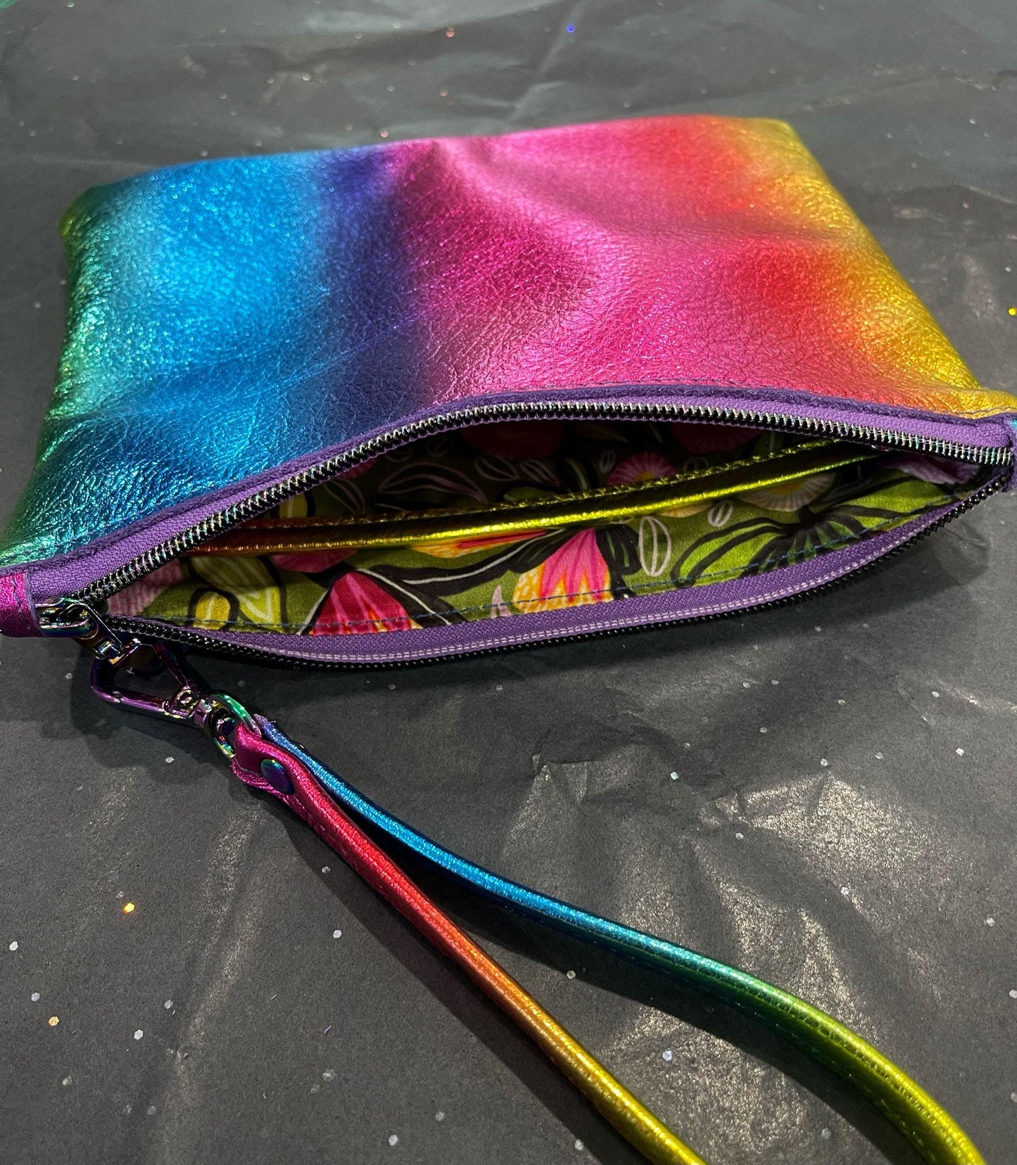 Multicolored pouch with a zipper on a black surface