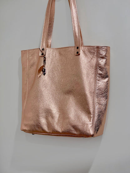 Rose gold tote bag on a light gray background