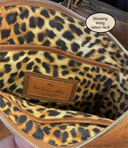 Leopard print lining inside tan leather bag with zipper closure