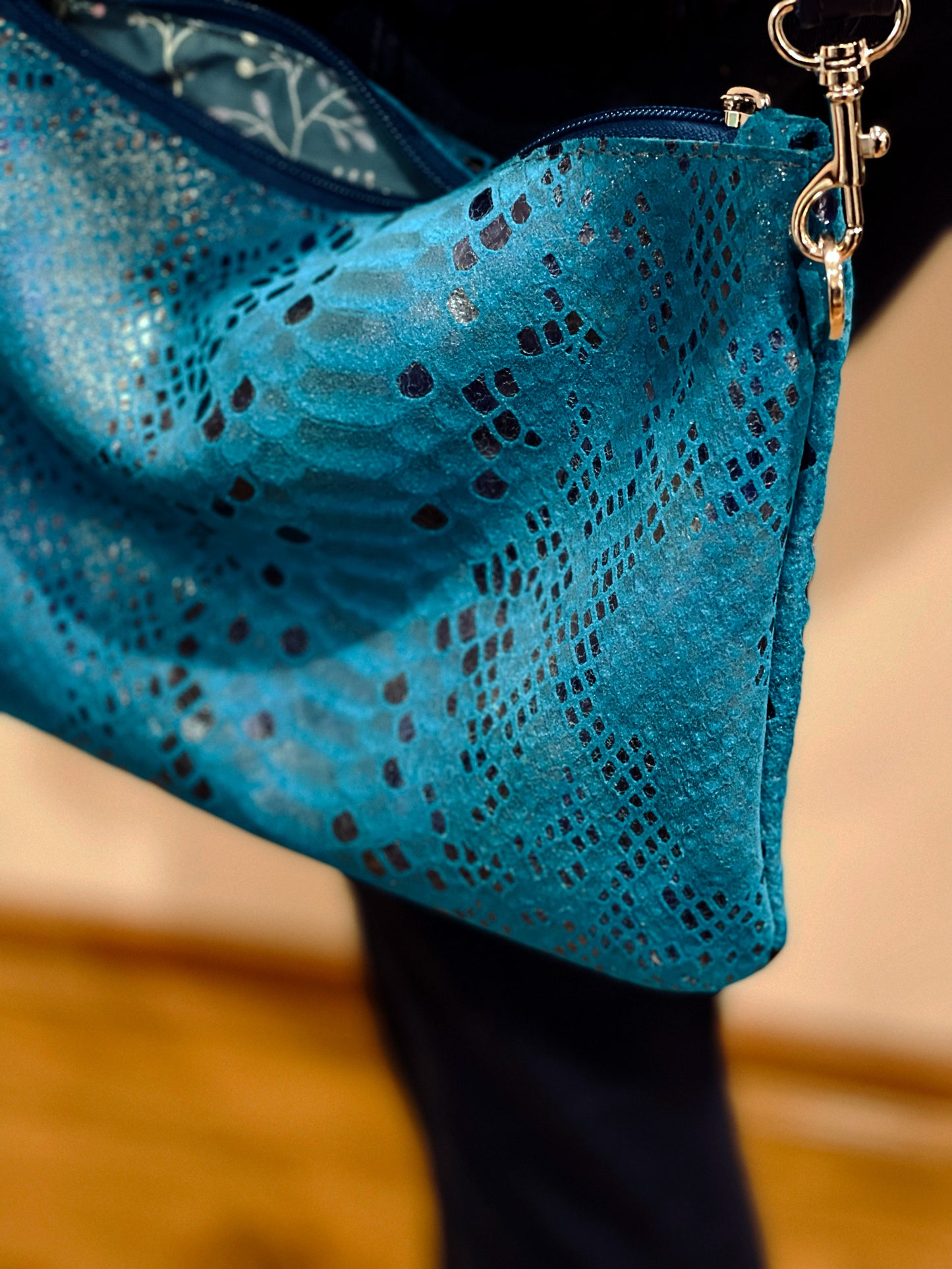 close up of turquoise Blue textured shoulder bag with gold hardware