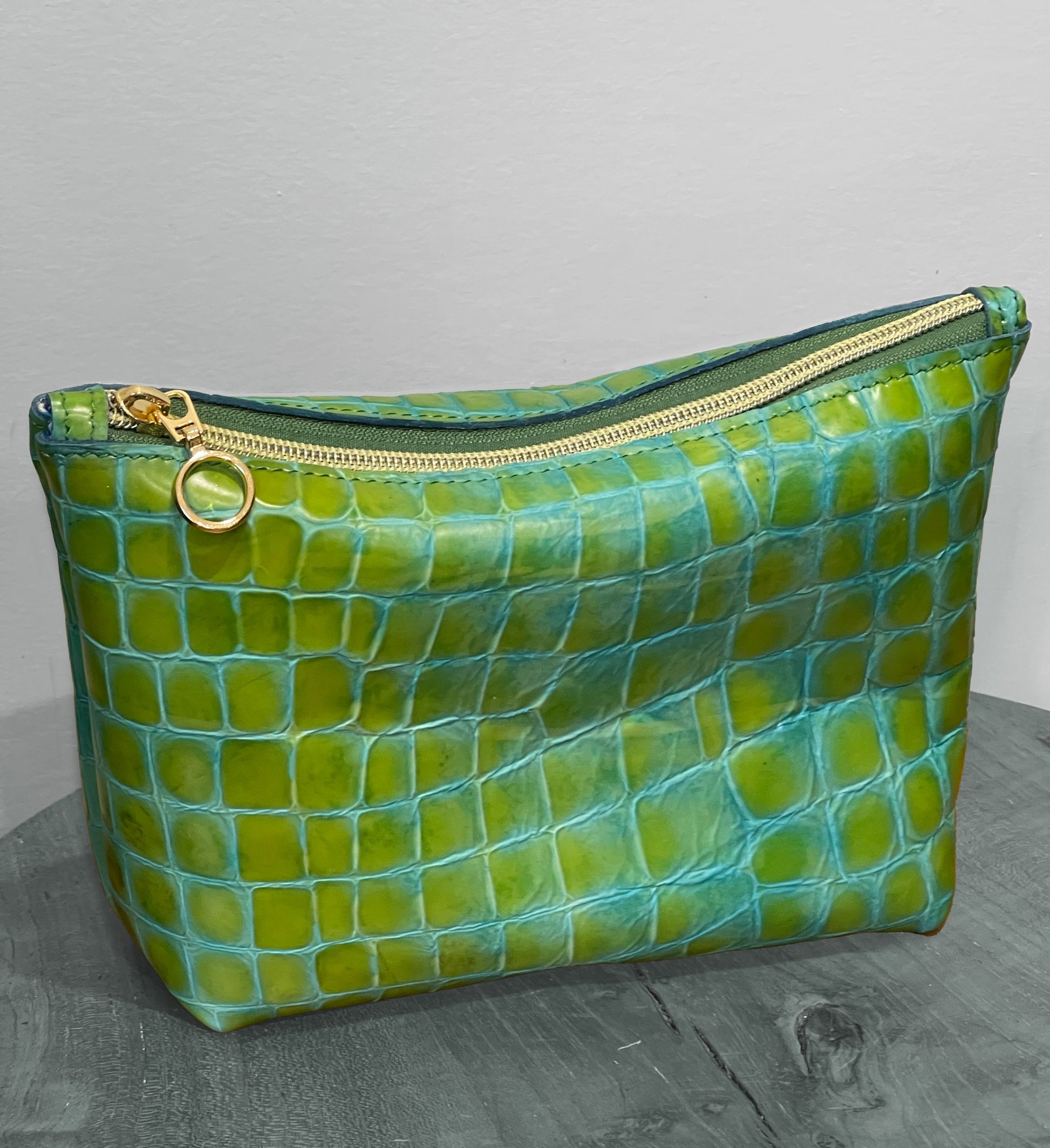 Green textured leather pouch with gold zipper 